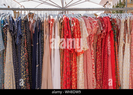 Dresses on coat rack on sale at street market in Aix-en-Provence, France Stock Photo
