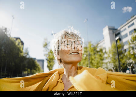 Portrait of smiling mature woman enjoying sunlight Stock Photo