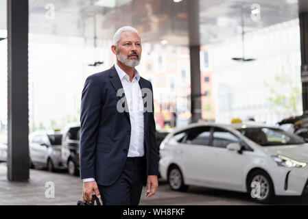 Mature businessman walking in the city Stock Photo