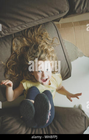 Portrait of little girl pulling funny faces Stock Photo