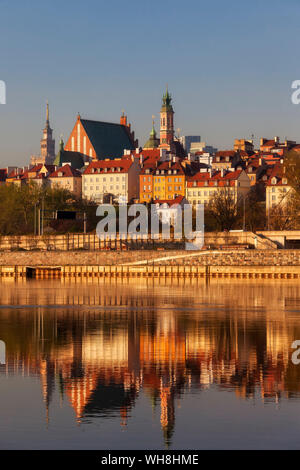 City skyline at sunrise, view across the Vistula River to the Old Town, Warsaw, Poland Stock Photo