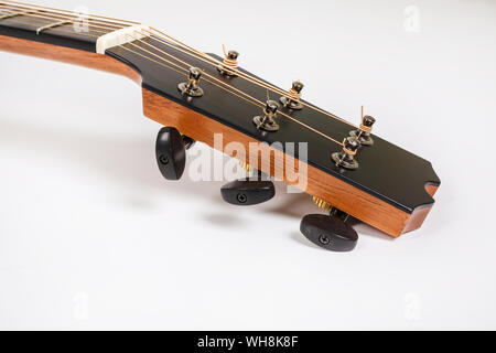 Tuning pegs on wooden machine head of six strings guitar on white background Stock Photo