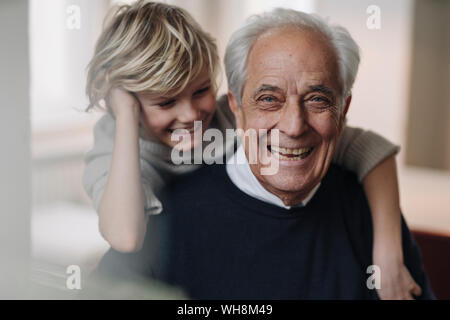 Portrait of happy grandfather and grandson at home Stock Photo