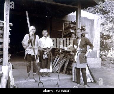 Father, mother and son with human toasting forks. 1900. Stock Photo