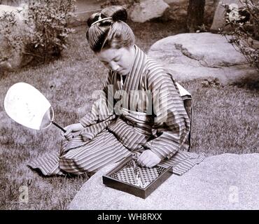 Japanese woman with a halma board. 1900. Stock Photo