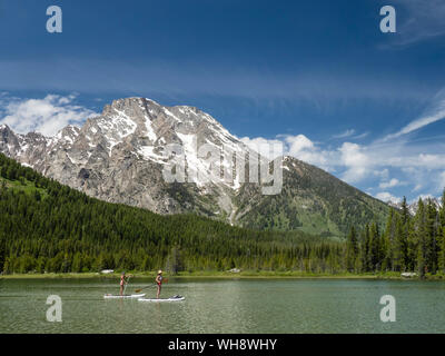 Stand up paddle boarders on String Lake, Grand Teton National Park, Wyoming, United States of America, North America