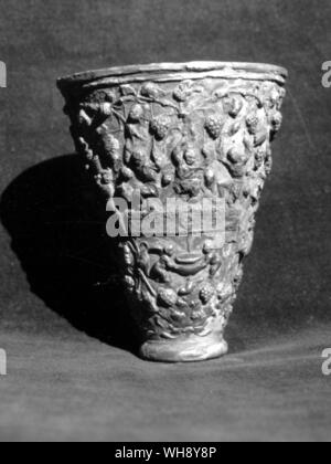 Silver-gilt drinking cup decorated with scenes from the vineyard. Greco-Roman period. Stock Photo