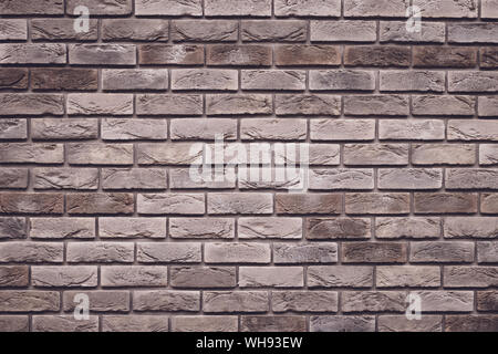 Brown brick wall background. Grunge texture. Vintage rough brickwork. Decorative tile surface. Bricks backgrounds. Messy wall pattern for wallpaper de Stock Photo