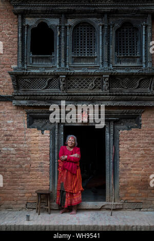 Traditional decorative Newari hand carved wood windows and architecture on a temple in an historical little village, Nuwacot, Nepal, Asia Stock Photo
