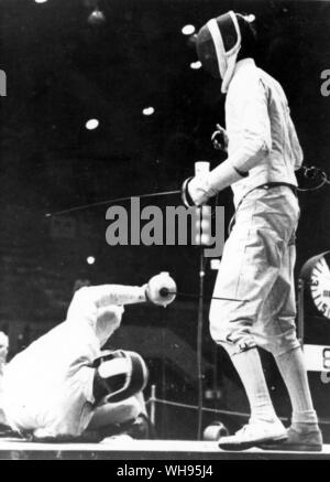 Japan, Tokyo Olympic Games, 1964: Grigory Kriss falls to the floor during the finals of the men's individual epee event versus Great Britain's, Bill Hoskyns. Kriss (USSR) won the gold medal and Hoskyns, the silver.. Stock Photo