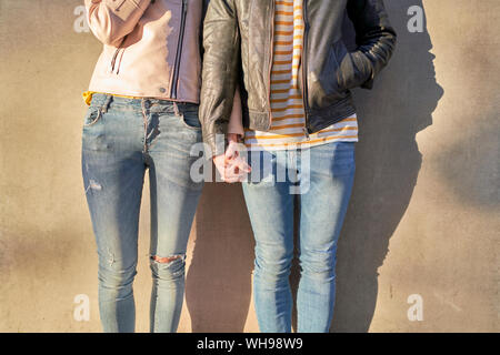 Couple in love holding hands, partial view Stock Photo