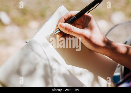 Woman's hand taking notes, close-up Stock Photo