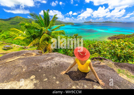 Panorama with woman looking to Cote d'Or Bay, with Curieuse, St. Pierre and Chauvre Souris Island, Anse Gouvernement, Praslin, Seychelles Stock Photo