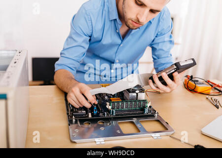Technician repairing a desktop computer Stock Photo