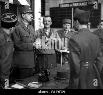 General Charles de Gaulle (1890-1970). French General and first president of the Fifth Republic, 1958-69. He enters liberated Paris in August 1944, with Le Clerc (centre bareheaded) and Juin on his arrival at Montpainasse Station. Stock Photo