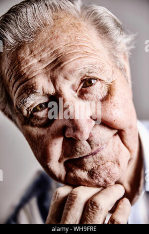 Portrait of senior man with hand on chin, close-up Stock Photo