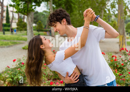 Young couple dancing in a park Stock Photo