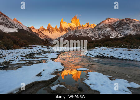 Mountain range with Cerro Fitz Roy at sunrise reflected in river, Los Glaciares National Park, UNESCO, El Chalten, Patagonia, Argentina, South America Stock Photo