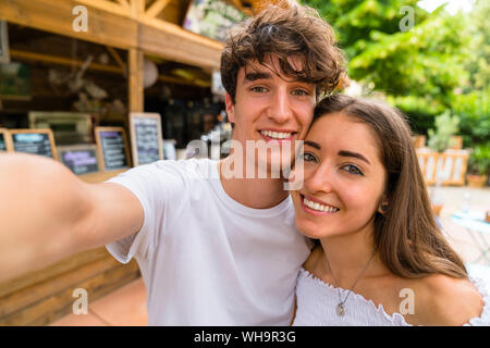 Young couple taking a selfie at a cafe Stock Photo