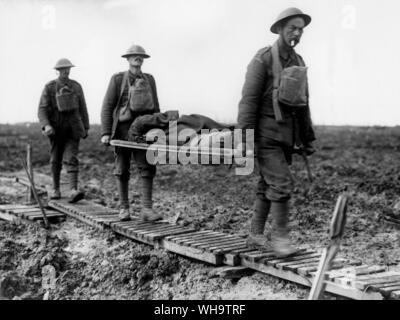 WW1/ France: First Battle of Passchendaele. Two guardsmen bringing in a wounded comrade on a streacher, near Langemarck, October 1917. Stock Photo