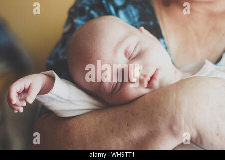 Portrait of baby boy sleeping in grandmother's rams