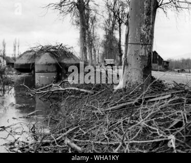 WW2: Camouflaged pillbox guarding the highway, was strongly defended by Nazis during the conflict that surged across Colmar Plain, near Ulhaeusern, France. Melting snow added to flood waters. 7th Feb. 1945. Stock Photo