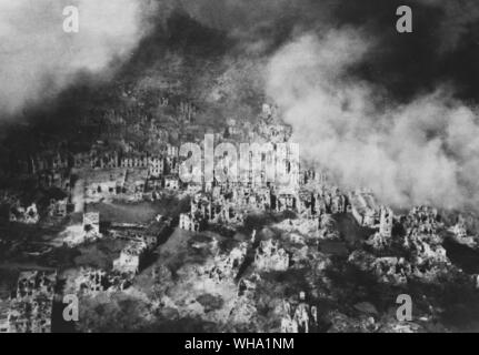 WW2: Aerial view of Cassino showing skeleton buildings covered with pall of smoke. March 1944. Stock Photo