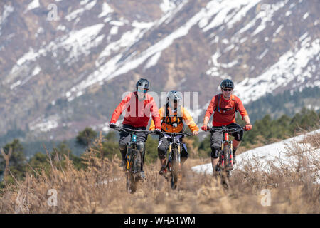 Mountain biking in the Himalayas with views of the Langtang mountain range in the distance, Nepal, Asia Stock Photo