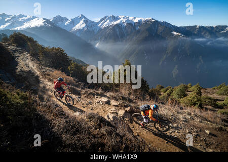 Mountain biking along a Enduro style single track trail in the Nepal Himalayas near the Langtang region, Nepal, Asia Stock Photo