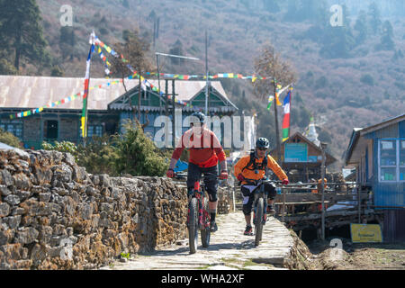 Mountain bikers in the little village of Sing Gompa in the Gosainkund region in the Himalayas, Langtang region, Nepal, Asia Stock Photo