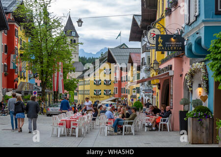 View of visitors enjoying drinks outside cafe on Vorderstadt, Kitzbuhel, Austrian Tyrol Region, Austria, Europe Stock Photo