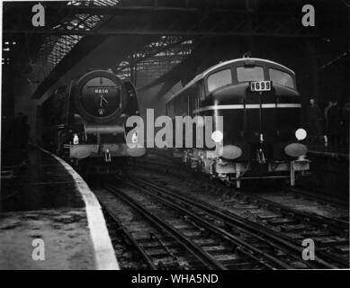 The Diesel Electric Locomotive ( DMS Railway ) pulling out of Euston Station. Also in the picture is one of the latest type of LMS Locomotive. 18th December 1947 Stock Photo