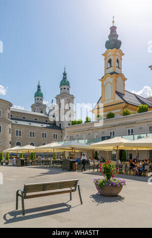 View of St. Michaelskirche and Salzburg Cathedral in Residenzplatz, Salzburg, Austria, Europe Stock Photo