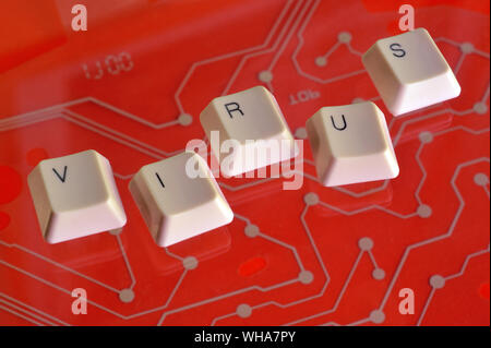 Keyboard keys form the word VIRUS on red electric circuit in the background. Stock Photo