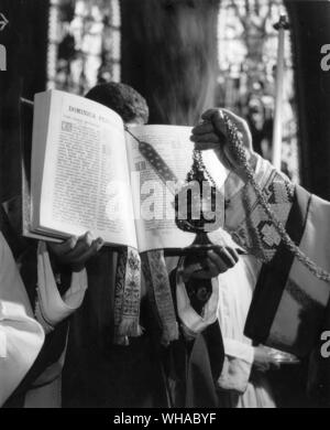 The singing of the Gospel at High Mass is accompanied by a procession and incensing of the book to mark the solemnity of the reading of the word of God. Stock Photo