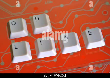 Keyboard keys form the word ON LINE on orange electric circuit in the background Stock Photo