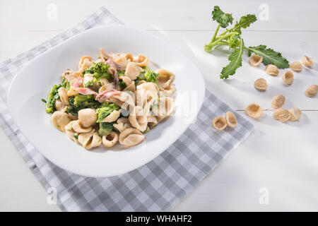 Vegetarian wholegrain Italian pasta, a traditional dish in Puglia, southern Italy, orecchiette with turnip greens and salted anchovies, top view with Stock Photo