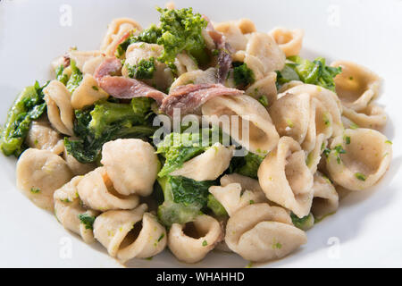 Vegetarian wholegrain Italian pasta, a traditional dish in Puglia, southern Italy, orecchiette with turnip greens and salted anchovies, close up Stock Photo