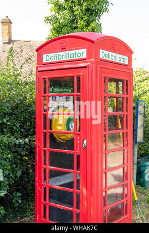 A defibrillator housed in an old red telephone box in the Cotswold village of Didbrook, Gloucestershire UK Stock Photo
