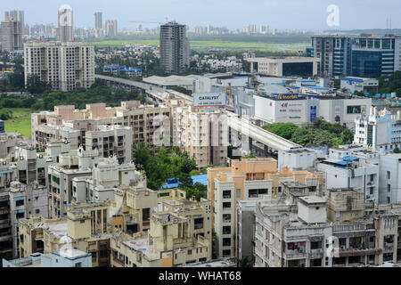 INDIA, Mumbai, urban development, skyscraper with expensive apartments in suburb Goregoan, Inorbit shopping mall and callcenter and BPO office buildings, bridge for new Mumbai Metro Stock Photo