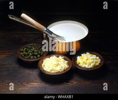 Basic White Sauce. with ingredients for egg cheese and caper variations Stock Photo