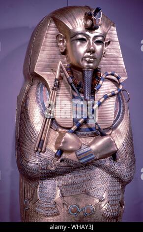 Tutankhamun Gold Sarcophagus. Tukankhamen, by Christiane Desroches Noblecourt, page 12857. The crook and flail are two of the most prominent items in the royal regalia. Kings held them across their chest. Stock Photo