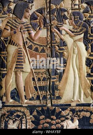 Painted ivory plaque from the lid of the coffer showing Tutankhamen and Queen Ankhesenamun in a garden. The lower frieze shows young women plucking mandrakes. Tukankhamen, by Christiane Desroches Noblecourt, page 29. Stock Photo