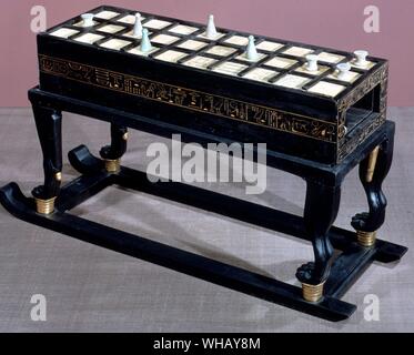 A game of Senet in ebony and ivory. This is the largest of three such objects found in the tomb. Tukankhamen, by Christiane Desroches Noblecourt, page 18.. This game table composed of interlocking pieces. The piece takes the form of a box resting on a base supported by four leonine legs, partially covered with gold leaf and fixed to a sledge. The upper surface is veneered with ivory and is subdivided by means of strips of wood into thirty squares, five of which carry inscriptions. The game of senet was played on this board. There are the same number of squares in ivory on the lower surface of Stock Photo