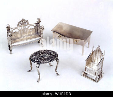 Group of miniature silver, including settee, Dutch, with English import mark for 1903. table, 1902. and a replica of the Coronation chair, 1901.. Claire Barrett Street Antique Market.. Stock Photo
