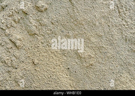 Texture of wet sand. Brown wet sand. Background of fine and wet sand. Sand background. Stock Photo