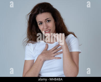 Portrait of young woman feeling scared and shocked making fear, anxiety gestures. Looking terrified and desperate. People and Human expressions, aggre Stock Photo