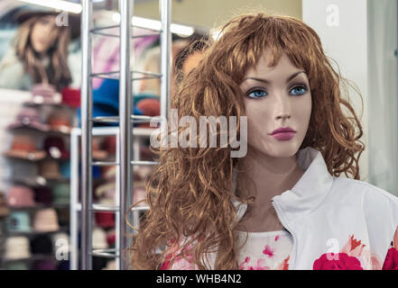 Female mannequin in a clothing store. Trading equipment - female plastic dummy. Stock Photo