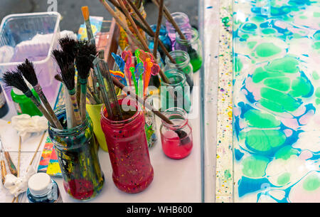 Tools for drawing on water in the technique of ebru. Putting paints on water with the subsequent transfer of the resulting pattern on paper. Stock Photo