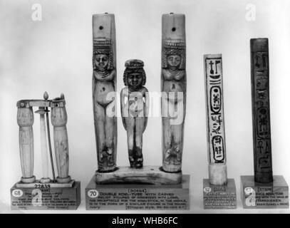 Double container for eye paint and the rod with which it was applied. Sets of Kohl tubes from Ancient Egypt - (l-r) double kohl-pot in the shape of two papyrus bud columns with a triangular lily column between the head of the kohl stock is in the shape of a bud XII dynasty - Double kohl tube with carved relief figures of goddesses with lions. The receptacle for the kohl stick in the middle is in the form of a similar figure in the round (Ethiopian style 8th-6th century BC) - Faience kohl tube inscribed in the name of Tutankhamen & the queen Ankhsenamen XVIII dynasty c.1360 BC - Faience kohl Stock Photo